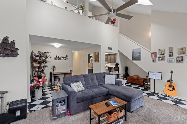 living area featuring stairway, visible vents, a ceiling fan, and tile patterned floors