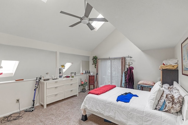 bedroom featuring light carpet, vaulted ceiling with skylight, and ceiling fan