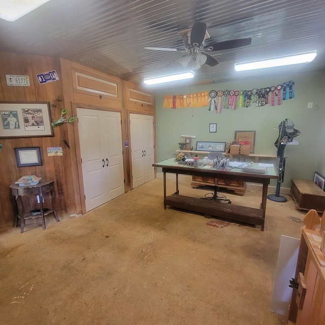 office with ceiling fan and wooden walls