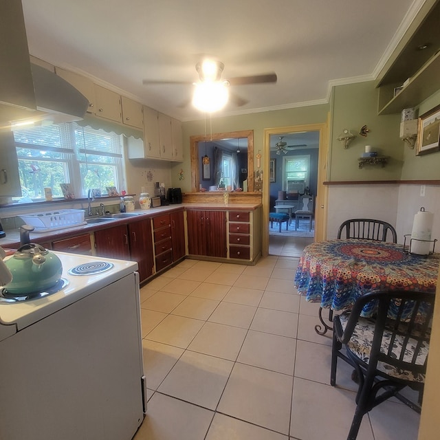 kitchen with crown molding, sink, ceiling fan, light tile patterned flooring, and range