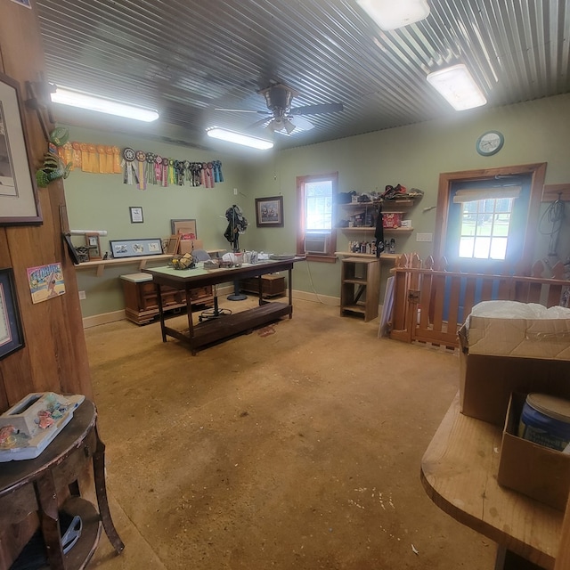 interior space featuring concrete flooring and ceiling fan