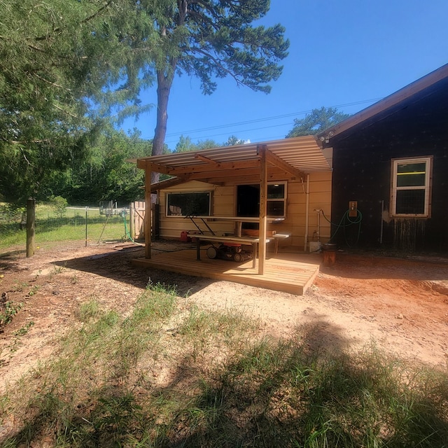 back of house with a wooden deck