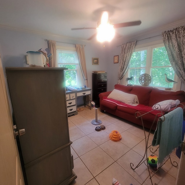 tiled living room featuring ceiling fan and ornamental molding