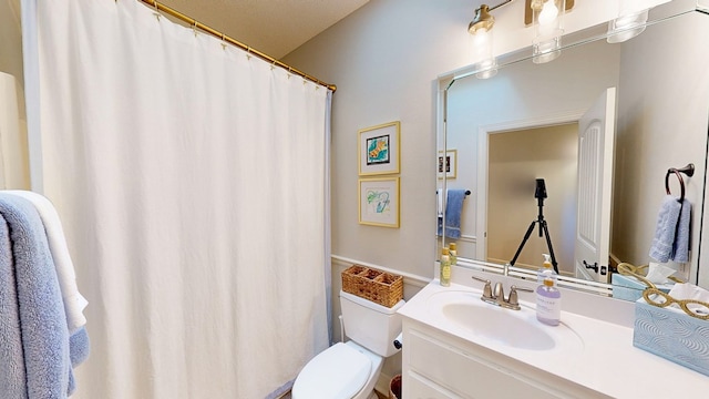 full bathroom featuring vanity and toilet