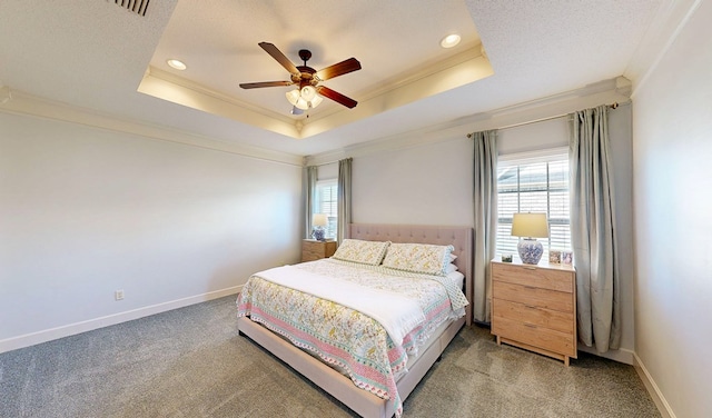 bedroom featuring multiple windows, a raised ceiling, and crown molding