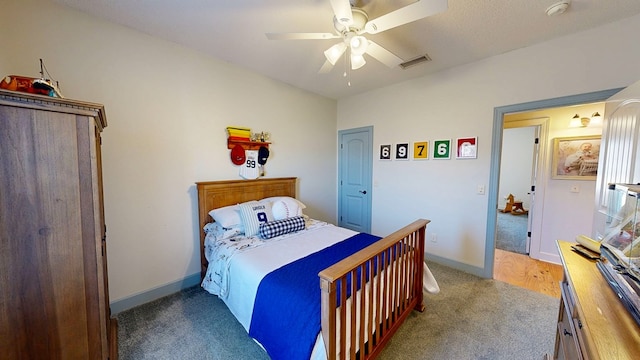 bedroom with a ceiling fan, visible vents, and baseboards