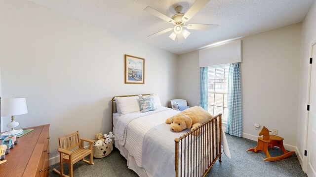 bedroom with carpet floors, a ceiling fan, baseboards, and a textured ceiling