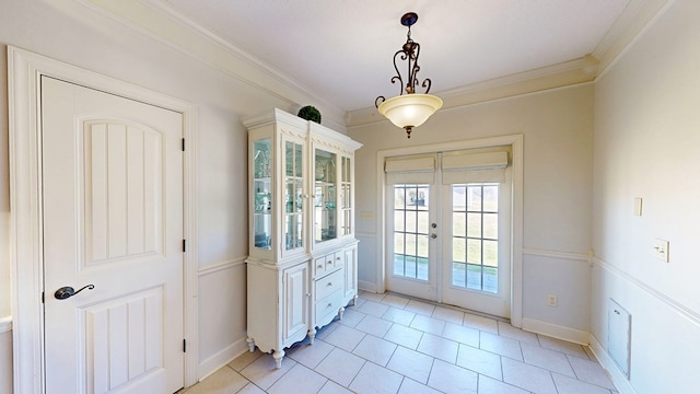 entryway featuring ornamental molding, french doors, and baseboards