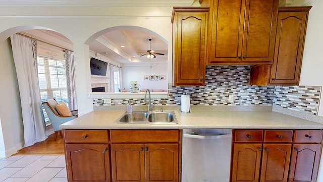 kitchen featuring light countertops, stainless steel dishwasher, and a sink