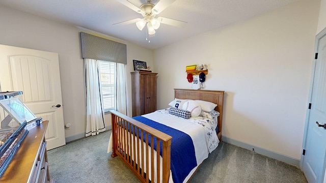 carpeted bedroom featuring ceiling fan and baseboards