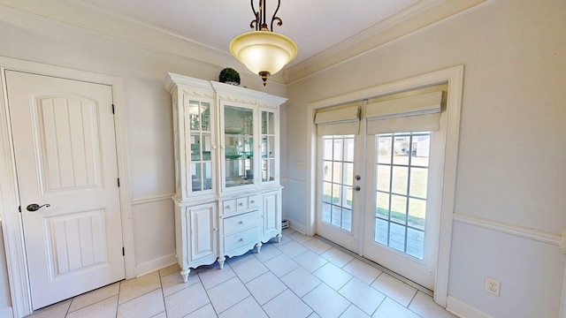 entryway featuring ornamental molding, french doors, light tile patterned floors, and baseboards