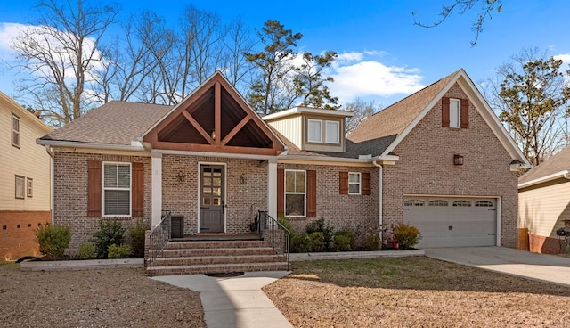 view of front of property featuring a garage, brick siding, and driveway