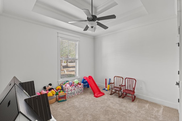 game room with ornamental molding, a tray ceiling, and carpet flooring