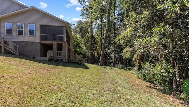 view of yard featuring stairs and a sunroom