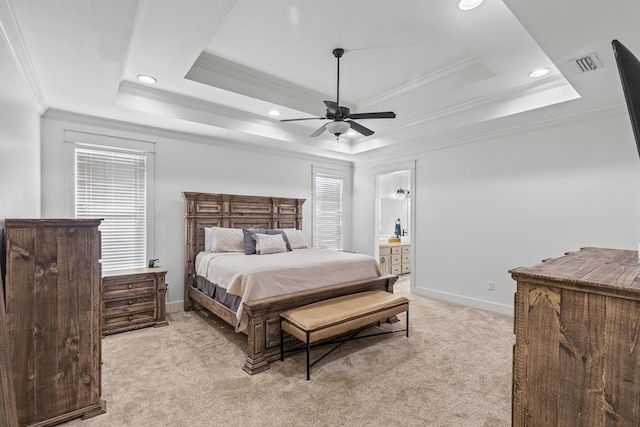 bedroom featuring light carpet, visible vents, baseboards, ornamental molding, and a tray ceiling