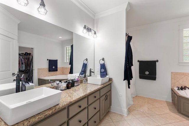 full bathroom with double vanity, ornamental molding, a tub to relax in, and a sink