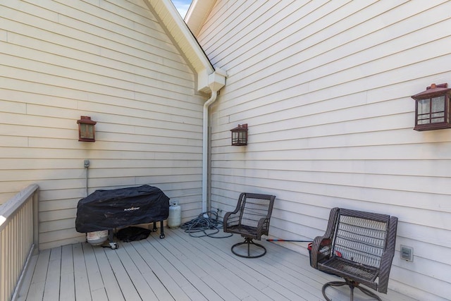 wooden terrace featuring a grill