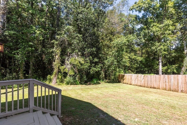 view of yard with fence and a deck