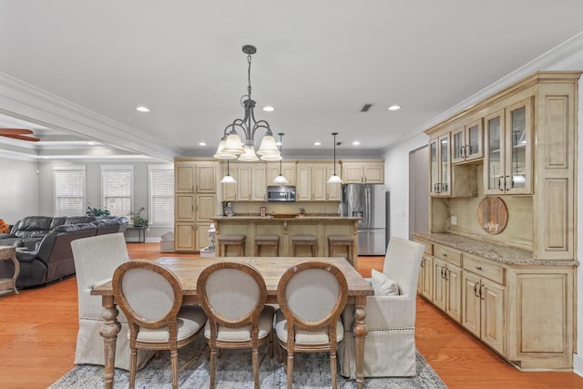 dining area with recessed lighting, light wood-type flooring, visible vents, and crown molding