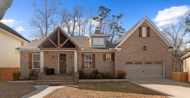 view of front of house with a garage, brick siding, driveway, and a shingled roof