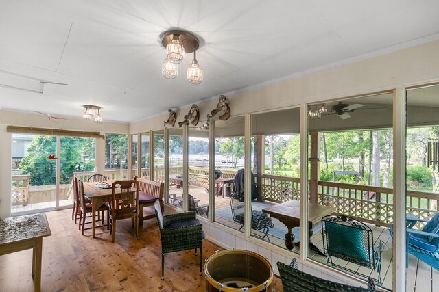 668 Lake Front Dr, Abbeville, AL 36310 - sunroom / solarium with outdoor dining area, wood finished floors, crown molding, and ceiling fan