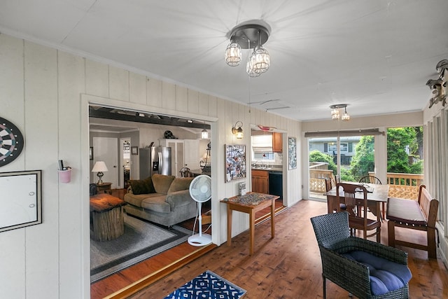 668 Lake Front Dr, Abbeville, AL 36310 - living room with crown molding, wood finished floors, and wood walls