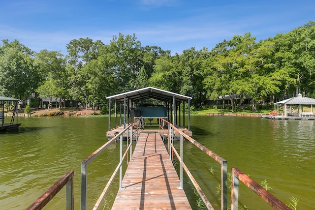 668 Lake Front Dr, Abbeville, AL 36310 - dock area with a water view, boat lift, and view of wooded area