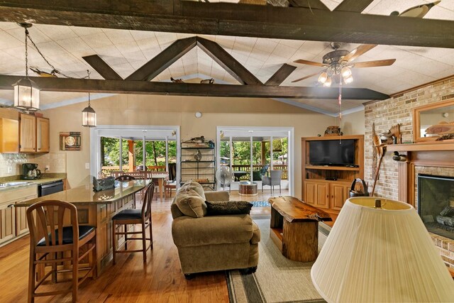 668 Lake Front Dr, Abbeville, AL 36310 - living area with wood finished floors, plenty of natural light, a fireplace, ceiling fan, and ornamental molding