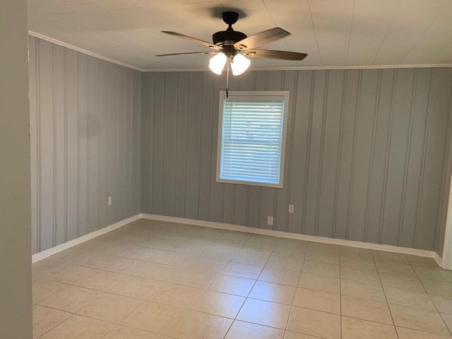 unfurnished room featuring crown molding, ceiling fan, and light tile patterned floors