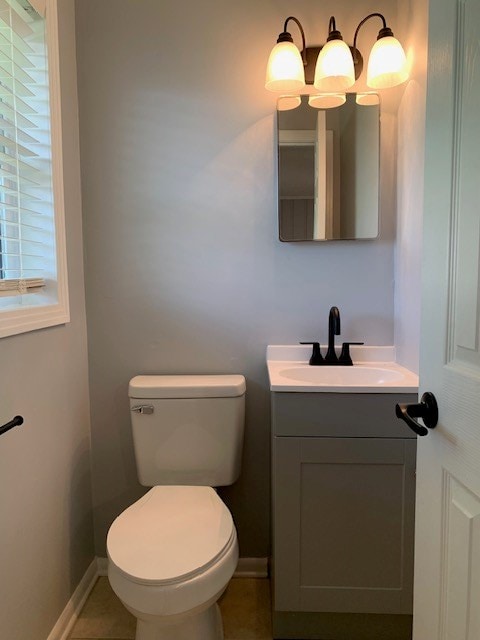 bathroom featuring toilet, tile patterned flooring, and vanity