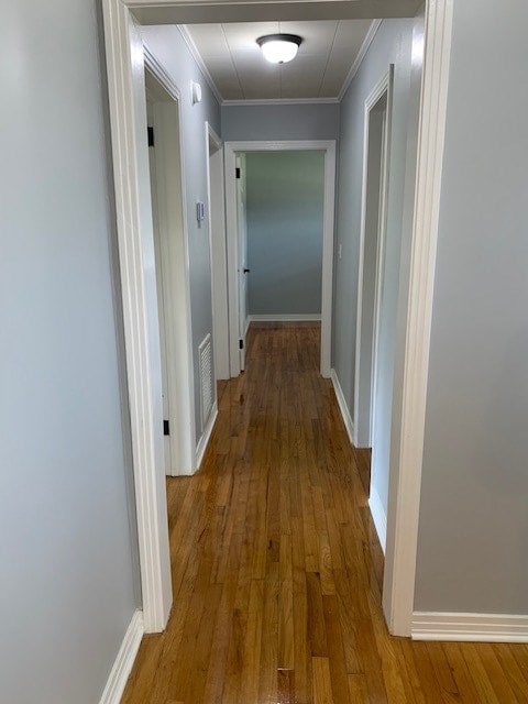 hall featuring ornamental molding and hardwood / wood-style floors