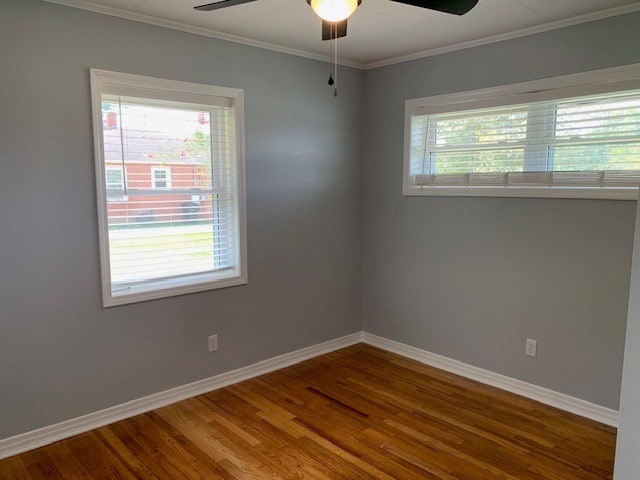 unfurnished room with hardwood / wood-style floors, a healthy amount of sunlight, ceiling fan, and ornamental molding