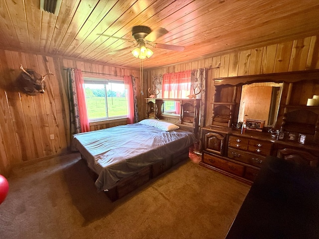 carpeted bedroom with wooden walls and wood ceiling