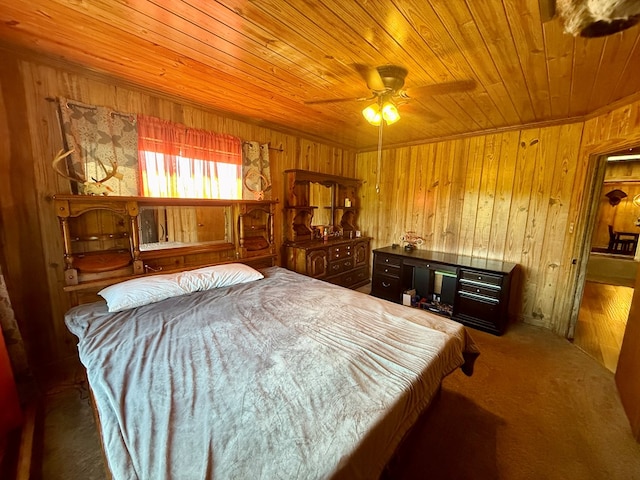 carpeted bedroom featuring wood walls, wood ceiling, and ceiling fan
