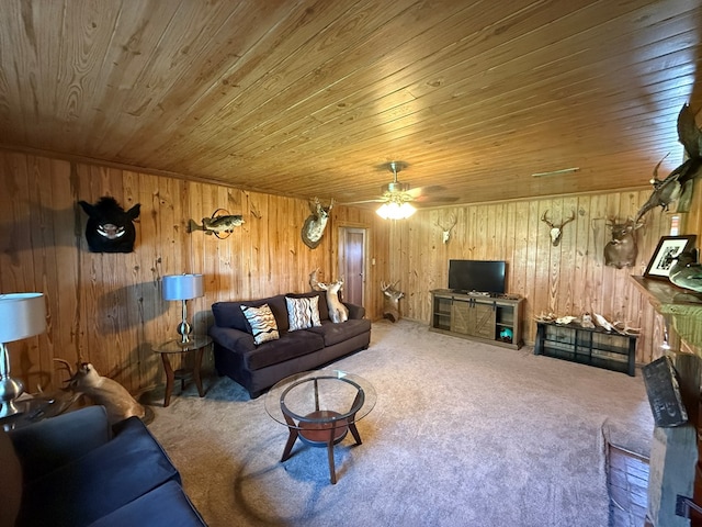 carpeted living area featuring wood walls, ceiling fan, and wood ceiling