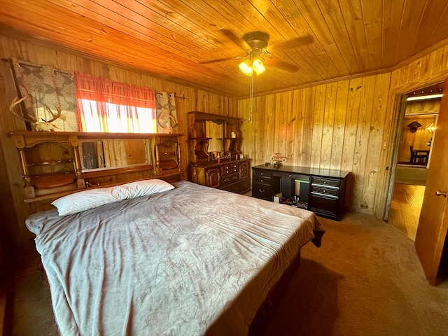 carpeted bedroom featuring wooden ceiling, wood walls, and ceiling fan