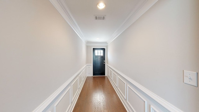 hallway featuring crown molding and dark hardwood / wood-style flooring