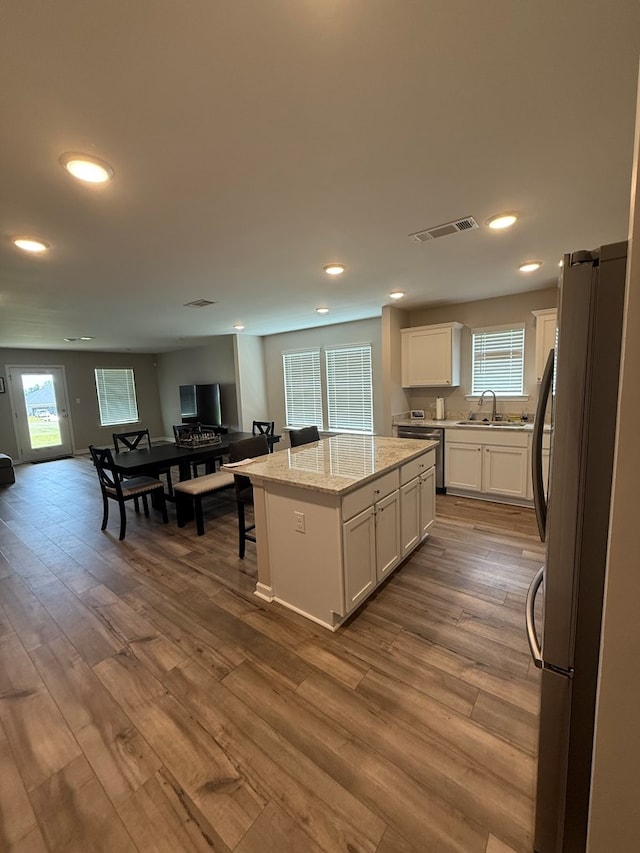 34 Popcorn Cir, Rehobeth, AL 36301 - kitchen with stainless steel appliances, a center island, dark wood-type flooring, white cabinetry, and recessed lighting