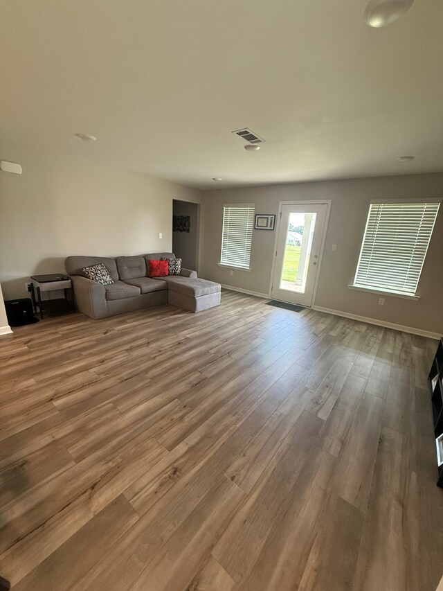 34 Popcorn Cir, Rehobeth, AL 36301 - unfurnished living room featuring wood finished floors and baseboards
