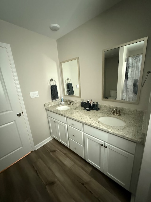 34 Popcorn Cir, Rehobeth, AL 36301 - full bathroom with double vanity and wood finished floors