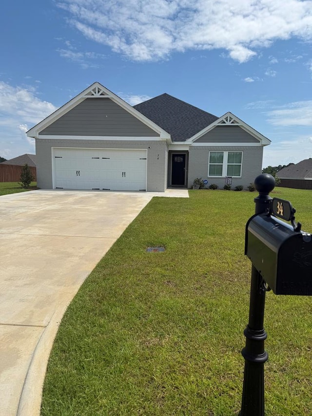 34 Popcorn Cir, Rehobeth, AL 36301 - view of front facade with driveway, a garage, and a front yard