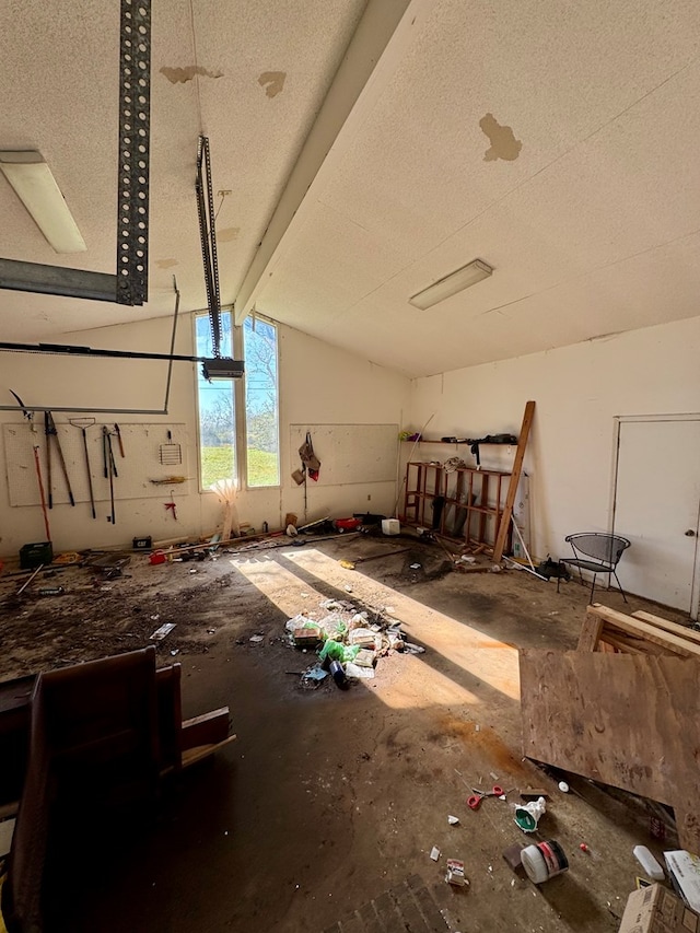 misc room with vaulted ceiling with beams and a textured ceiling