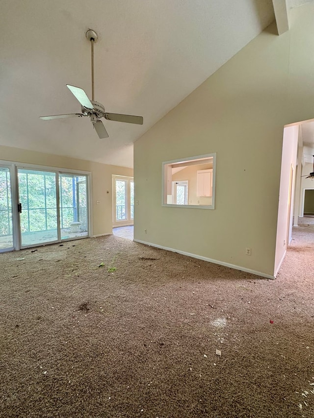 unfurnished living room featuring carpet flooring, ceiling fan, beamed ceiling, and high vaulted ceiling