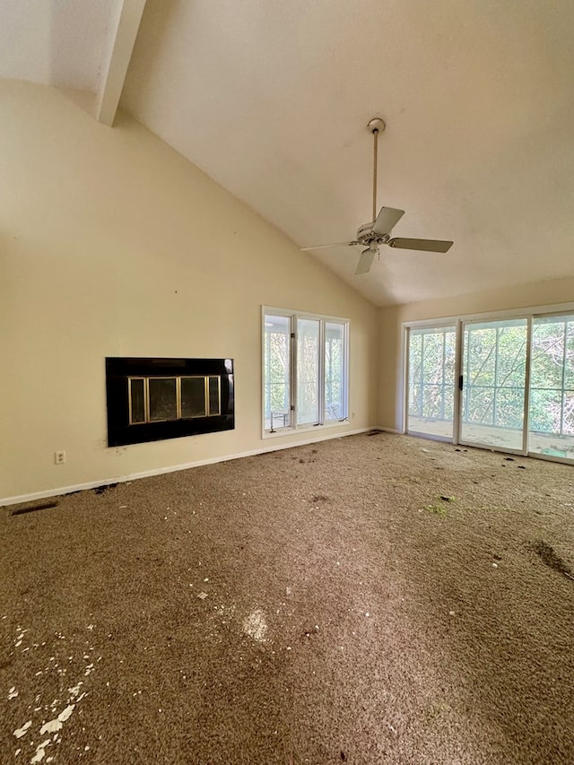 unfurnished living room featuring beam ceiling, ceiling fan, and carpet flooring