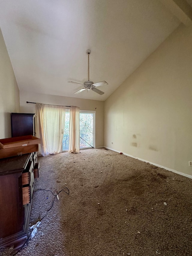 unfurnished living room featuring carpet flooring, vaulted ceiling, and ceiling fan