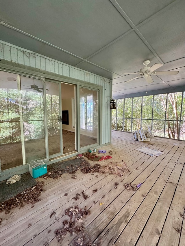 unfurnished sunroom featuring ceiling fan