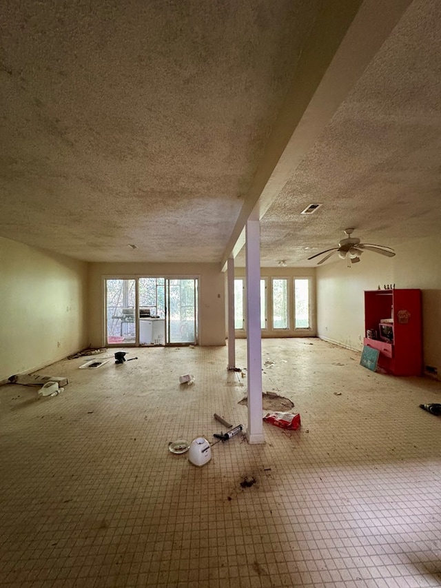 misc room with carpet flooring, a textured ceiling, and ceiling fan