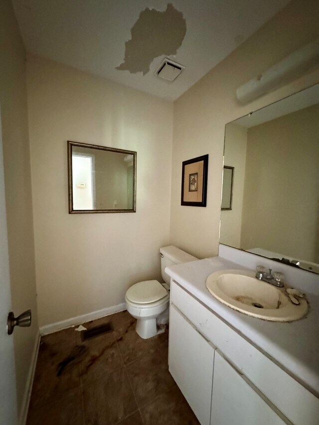 bathroom with tile patterned floors, vanity, and toilet