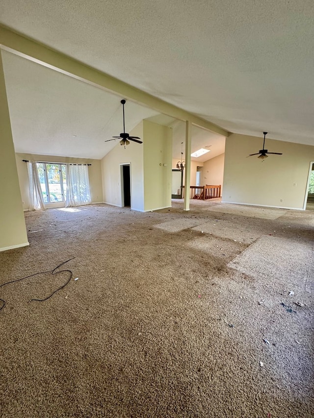 unfurnished living room featuring carpet flooring, lofted ceiling with beams, ceiling fan, and a textured ceiling