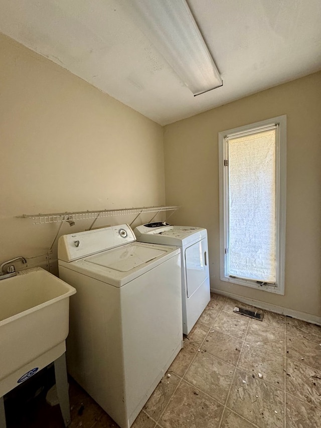 washroom featuring washer and clothes dryer and sink